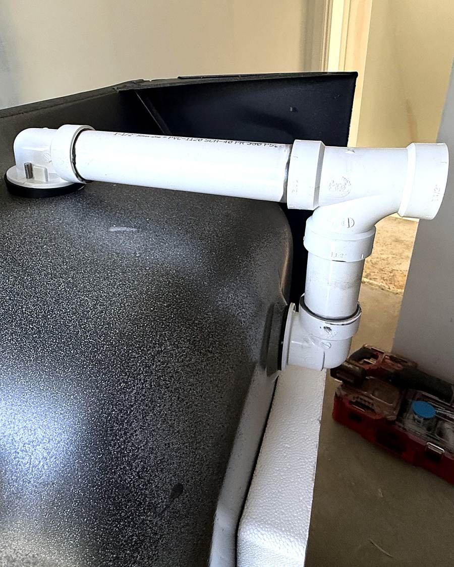 Open stud wall with white plastic water lines during a South Bend bathroom remodel