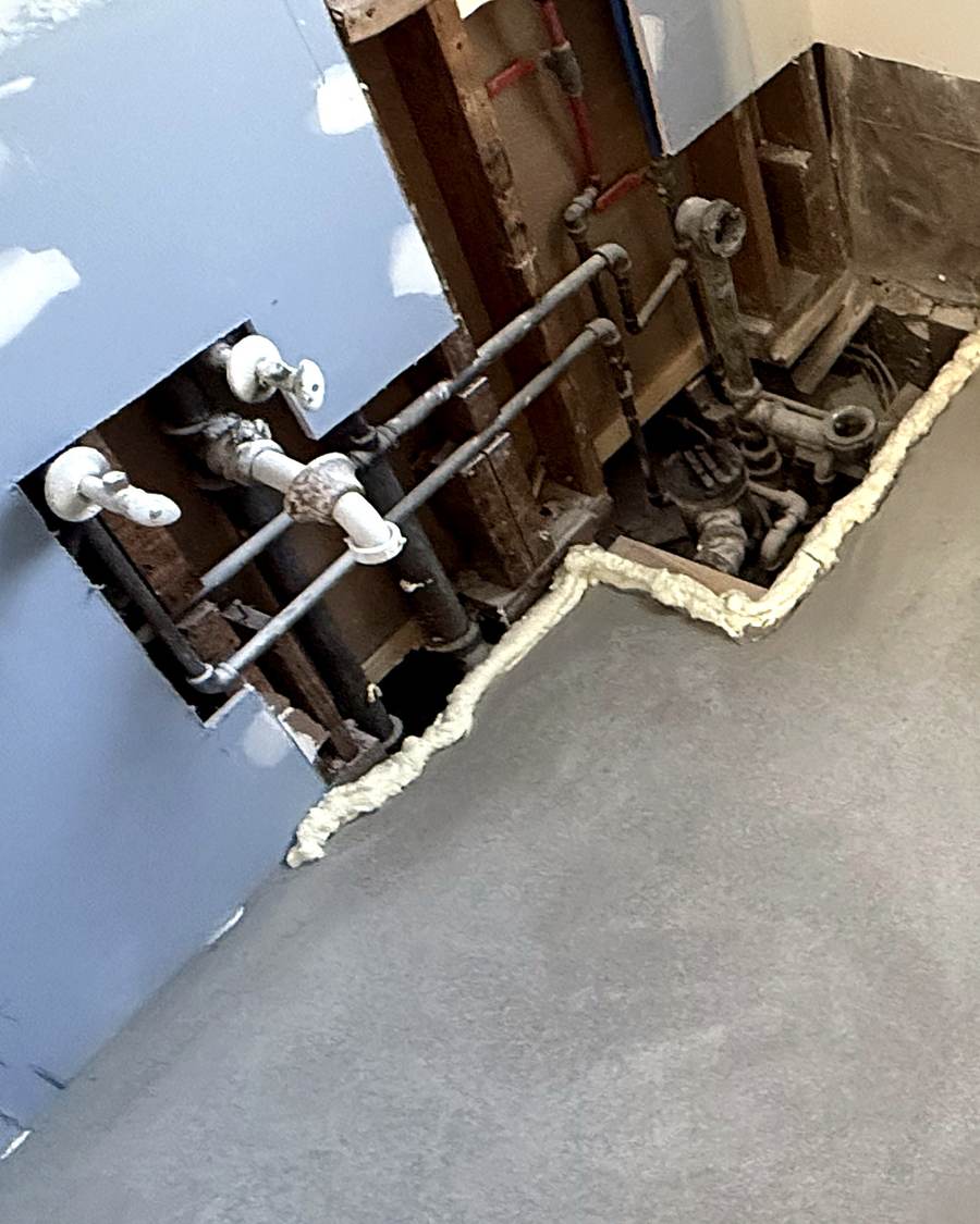 White plastic water lines in an open wall during a South Bend bathroom remodel