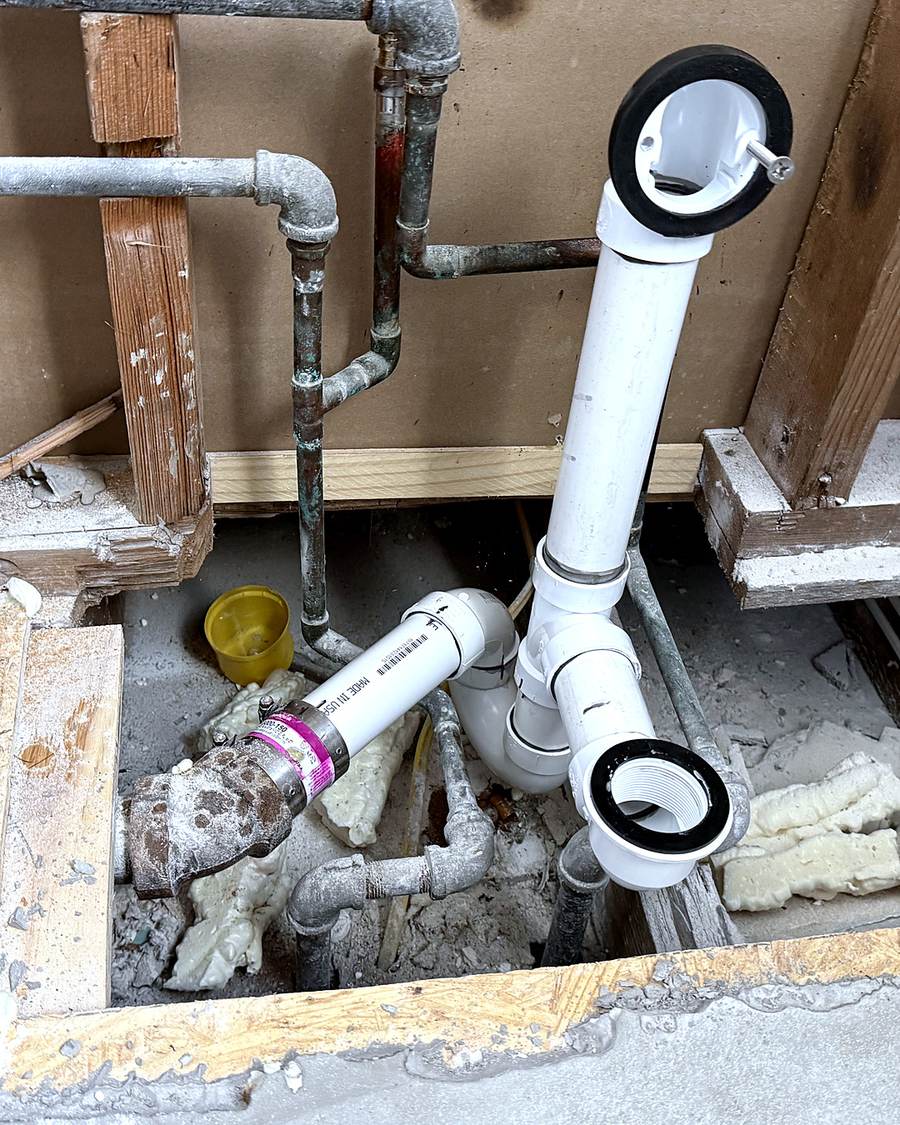 White plastic supply lines in an open wall during a South Bend bathroom remodel